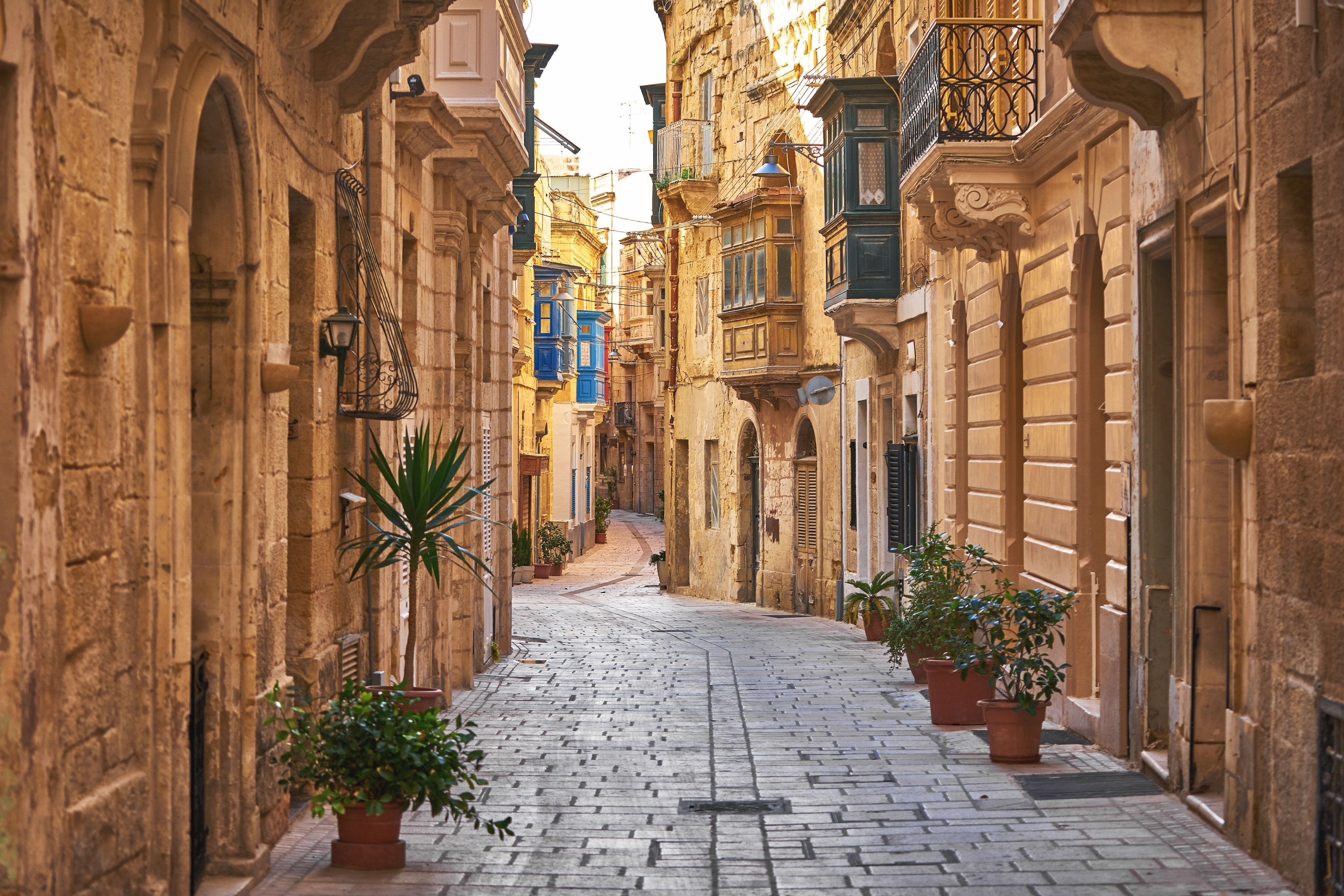 Limestone facades and traditional balconies on a street in Valletta